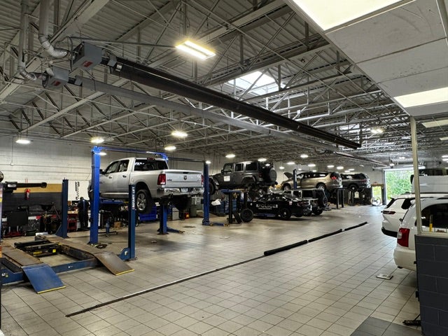 Technicians working under the hood of a Ram truck