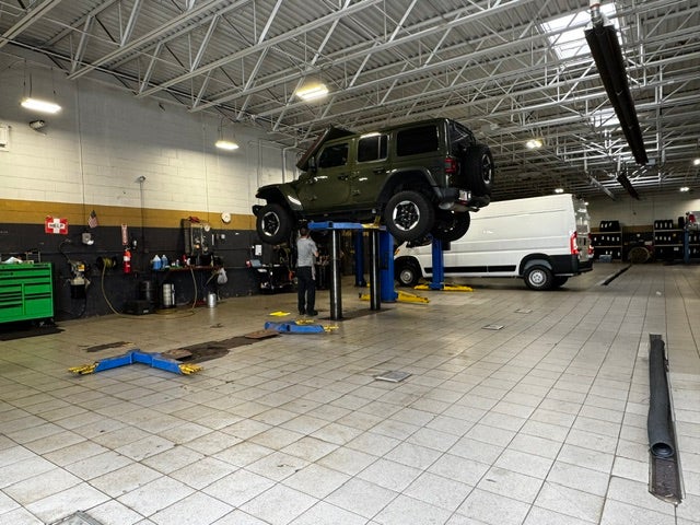 Ram diesel truck being serviced on a professional vehicle lift